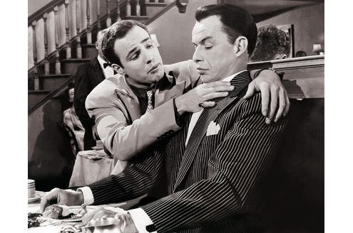 Guys and Dolls (1956): Frank Sinatra und Marlon Brando hatten am Set nicht viel für einander übrig. Brando soll seinen Text in dieser Szene mit Absicht vermasselt haben, so dass Frank Sinatra weiter Käsekuchen essen musste. (c) Marlon Brando - Eine Hommage in Fotografien