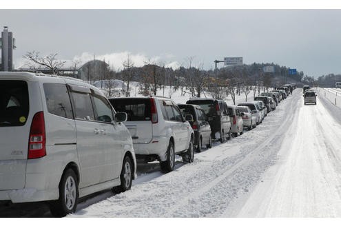 Vehicles forma a long line to queue up for fuel in Ichinoseki city, Iwate prefecture on March 17, 2011. The official toll of the dead and missing following the devastating earthquake and tsunami that flattened Japan's northeast coast has topped 11,000, with 3,676 confirmed dead, police said. The total number of people unaccounted for in the wake of Friday's twin disasters rose by more than 800 to 7,558, the national police agency said in its latest update. AFP PHOTO / JIJI PRESS 