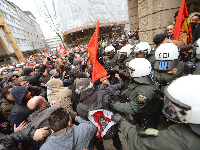 Polizisten sichern eine Kundgebug von Salafisten vor Gegendemonstranten.