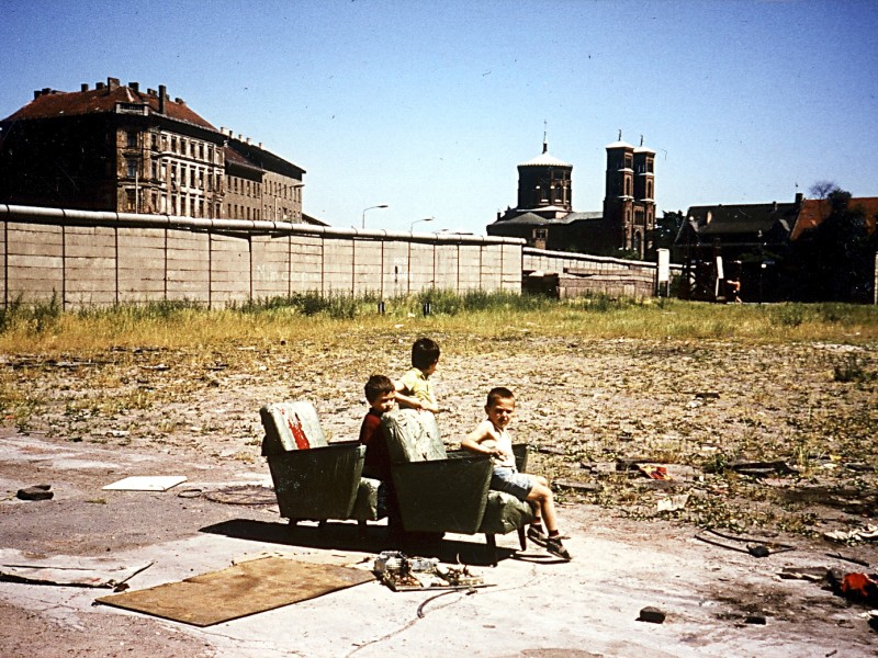 Auch West-Berlin wird durch die Mauer geprägt, vor allem die Stadtteile, die unmittelbar an der Sektorengrenze liegen. Im Schatten der Mauer entstanden oft verwahrloste Brachen und Freiflächen, die als Parkplätze, Müllablagen oder wilde Gärten dienten. Spielende Kinder, Künstler und Autonome nutzten sie hingegen oft als Freiraum für ihre Aktivitäten.