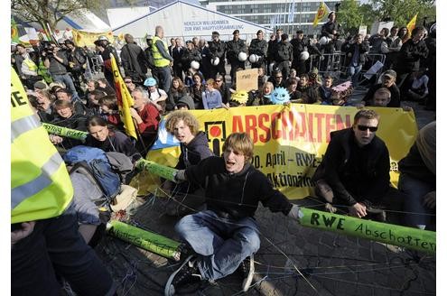 Vor der RWE-Hauptversammlung protestieren Atomkraft-Gegner gegen die Technologie. In der Grugahalle muss sich Konzernchef Jürgen Großmann heftige Kritik der Aktionäre anhören. Foto: ap