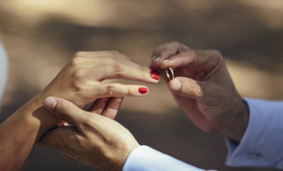 Hochzeit BrÃ¤utigam steckt Braut Ring an den Finger