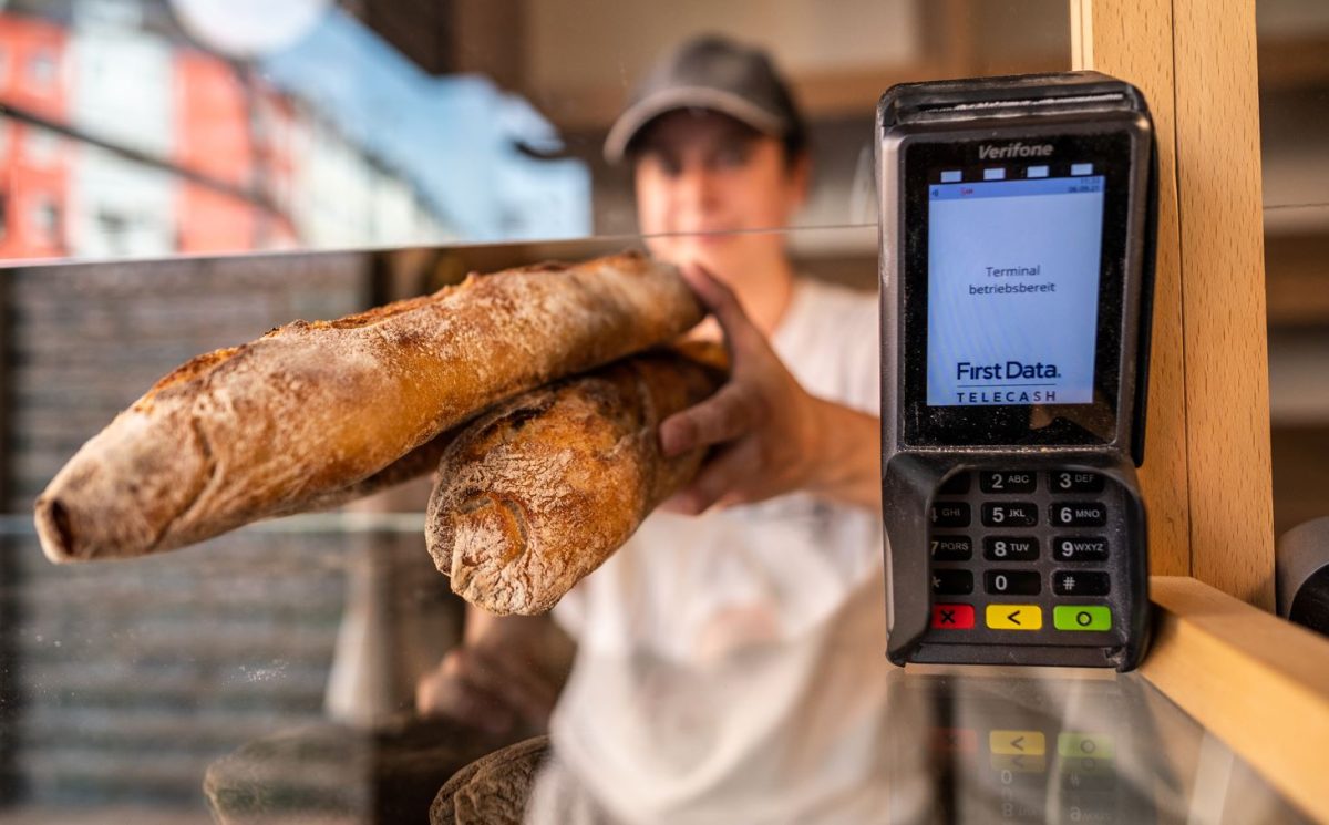 Eine Bäckerei-Mitarbeiterin aus NRW reicht zwei Brote und verlangt die Zahlung mit EC-Karte.